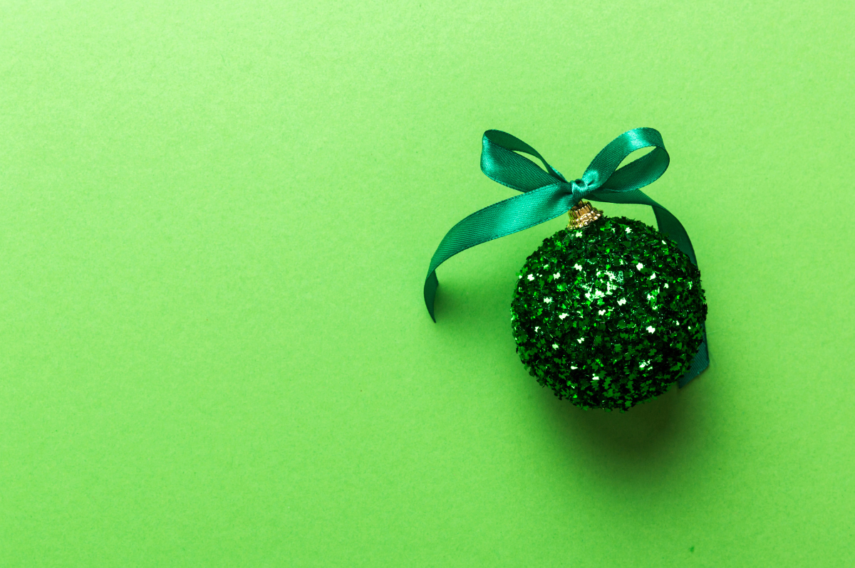 Green background with a sparkly green bauble to accompany a news post about the Christmas Opening hours at Kingsbury Pallets